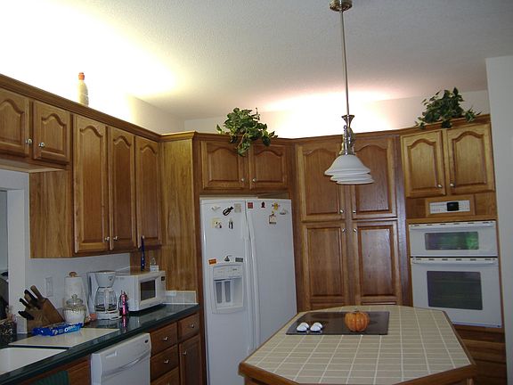 Kitchen with Custom Cabinets, Double Ovens, center Island with Cooktop 