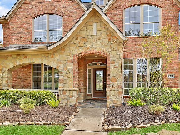 Rustic front porch with covered seating area from which to watch the world go by. Stunning stone architectural accents. Huge picture windows light up this lovely home.