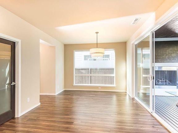 Dining area overlooking covered backyard with Fireplace