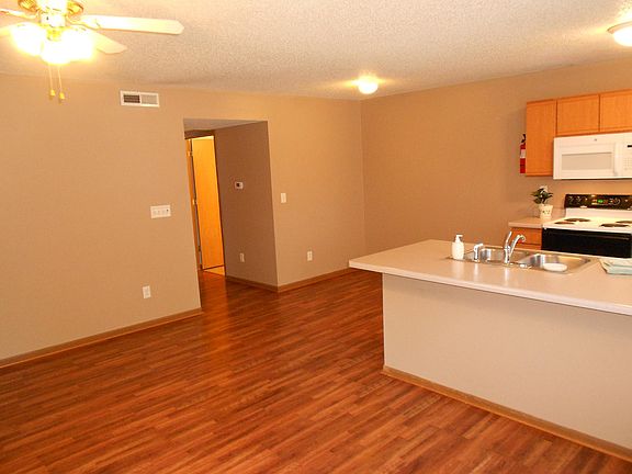 Entry viewing living room and kitchen