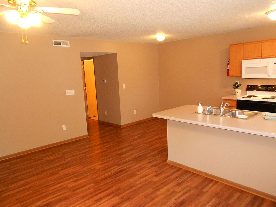 Entry viewing living room and kitchen
