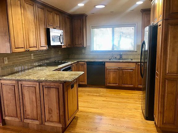 Kitchen: Granite countertops, electric cook top, instant hot water, lots of storage. Sun tunnels and large window bring in a lot of natural light