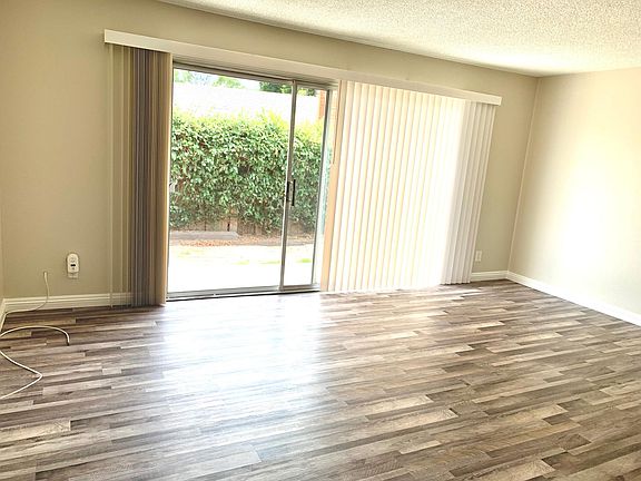 Living room area with large patio door, excellent natural lighting.