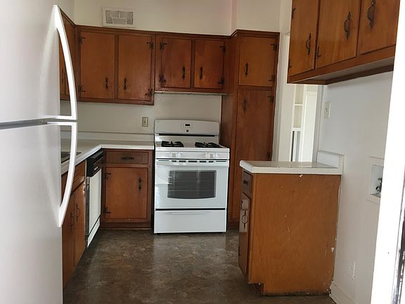 Kitchen includes fridge, gas stove and fridge