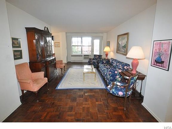 The screened in private corner terrace overlooks tree lined Garth Road and Garth Road Park (playgrou