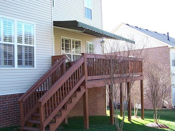Rear of home.  Deck has retractable awning and gas grill with rotissere.