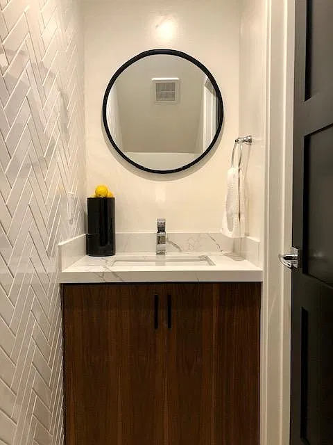 Downstairs Bathroom w Custom Vanity and Herringbone Tile