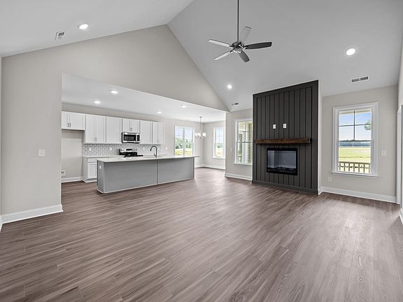 Open floor plan with cathedral ceiling in living room