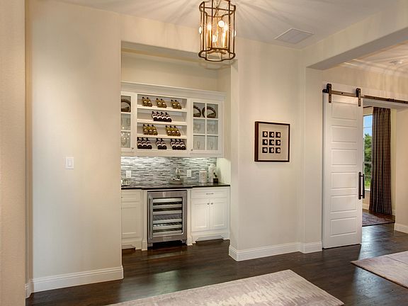 Pantry with wine cooler and glass cabinets