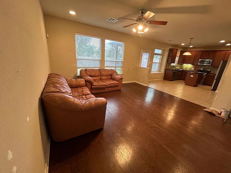 Living room and kitchen. Leather sofa can stay