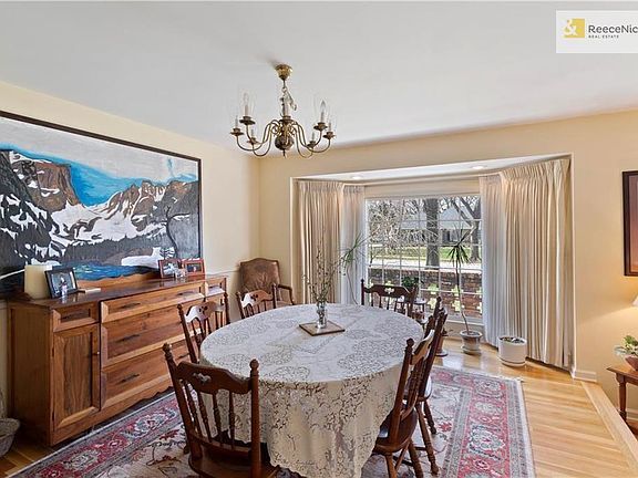 The dining room, a step up from the family room, features its own large bay window.