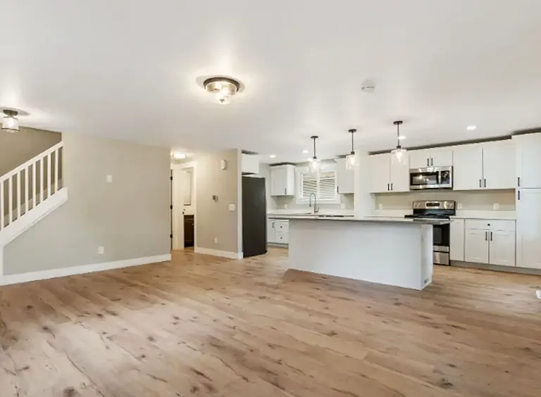 Open living room and kitchen with large island.