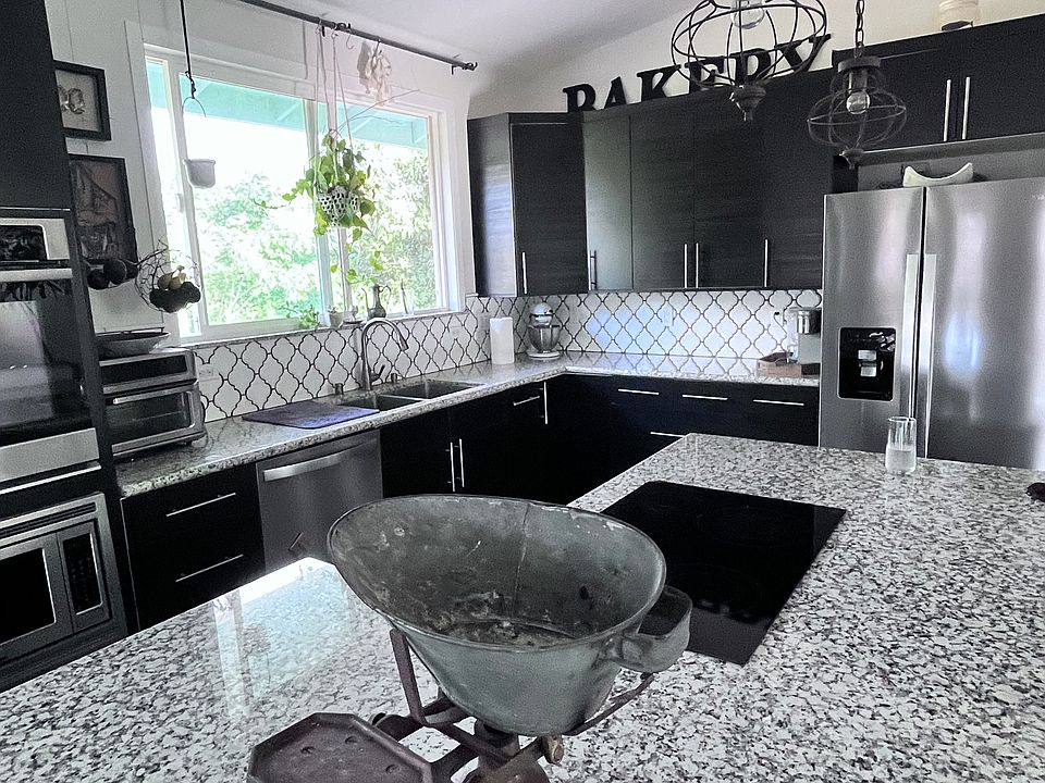Kitchen has granite counter tops, pantry, soft closing drawers, glass top induction stove, dishwasher, garbage disposal, built in oven and microwave.