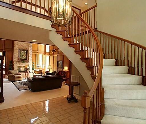 Two story foyer with circular staircase.