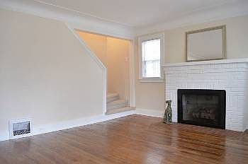 The living room stairs lead up to the second level with two bedrooms above.