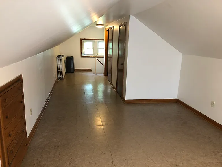view from opposite end of room leading to the stairway