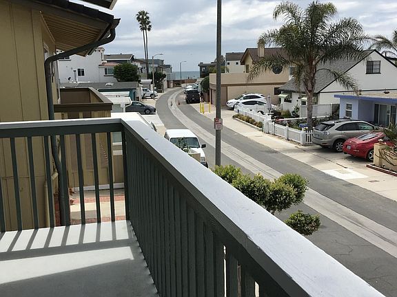 View from second floor balcony abutting living room, with view of ocean 350 feet down Hanover Lane.