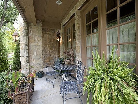 Covered front porch leads to elegant entry 