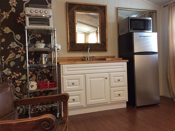 Kitchenette with fridge,microwave, toaster oven. Dishes, and misc. supplies..