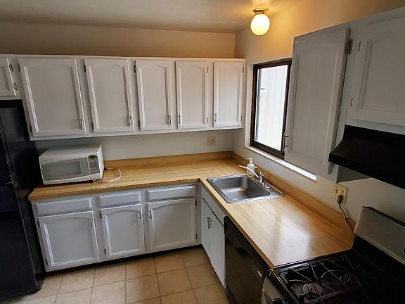 Kitchen with refrigerator, microwave, dishwasher, and gas range