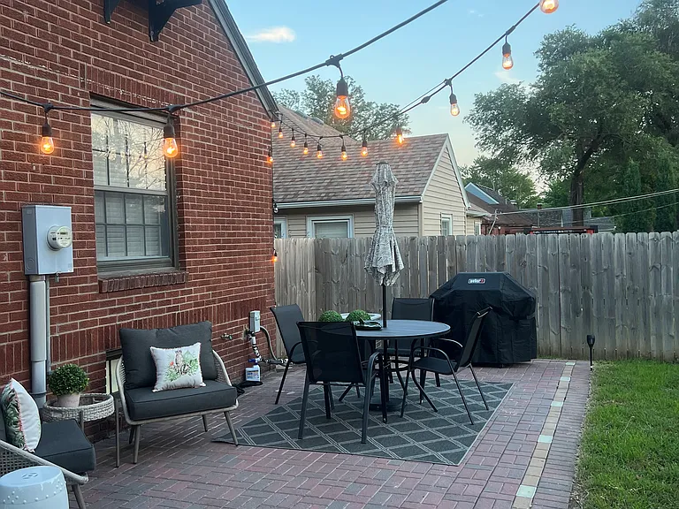 Weber grill, party lights and outdoor dining table