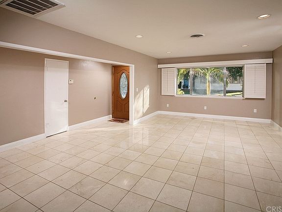 The living room is bathed in natural light from a