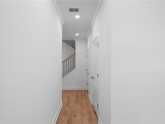 light flooring, white walls, foyer entry way with powder room and hall closet for all rain gear, jac