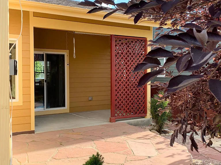 Sandstone patio and enclosed patio. Sandstone patio has retractable awning.