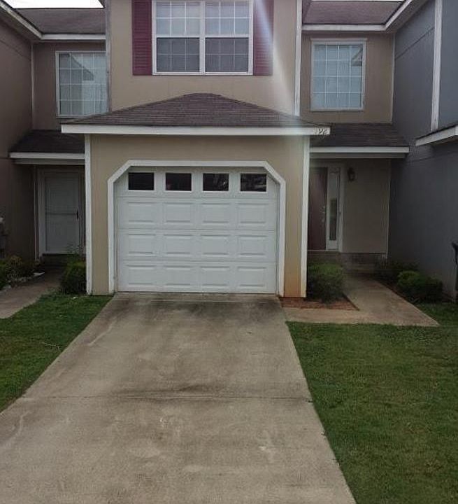 Outside, with single car garage and fenced in backyard behin