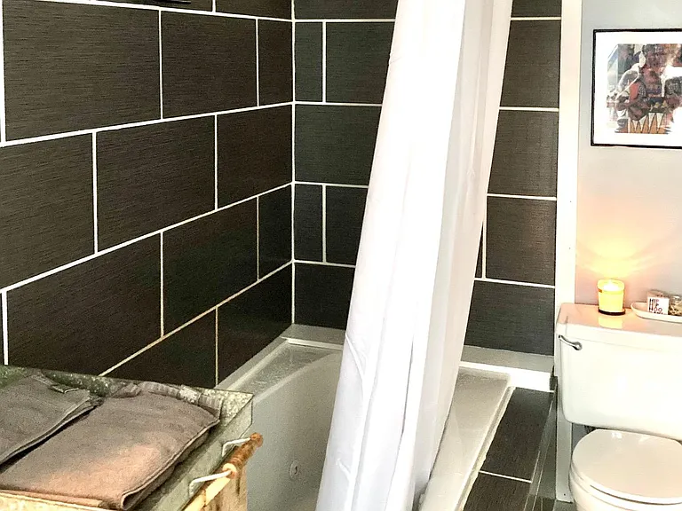 Tiled bathroom with jacuzzi tub.