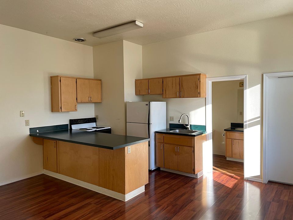 Kitchen with view to bath and front door.