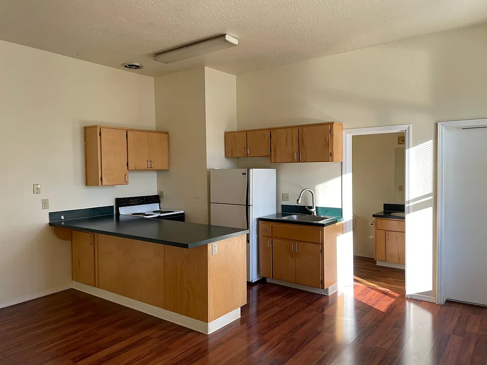 Kitchen with view to bath and front door.