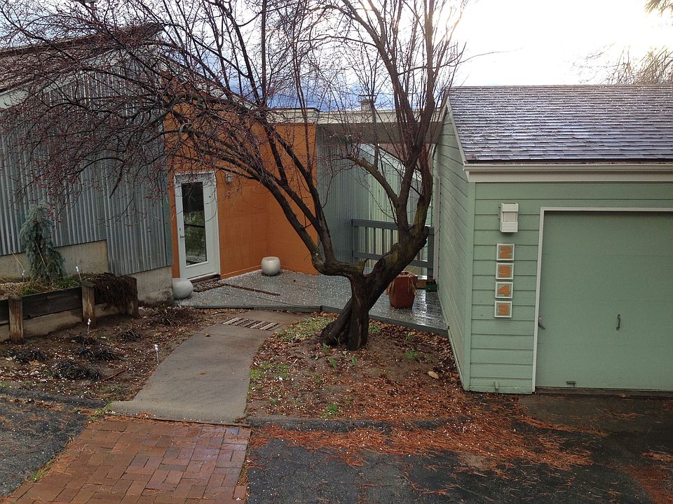 Front with pink blossoming dogwood.