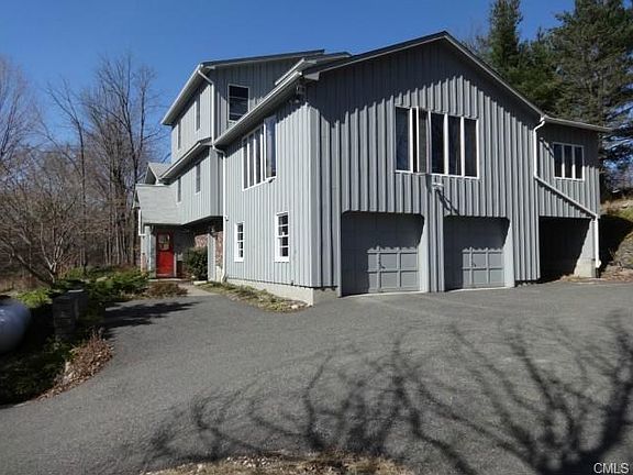 Large 2-bay garage with extra shed space to the right, under sunroom with hot tub