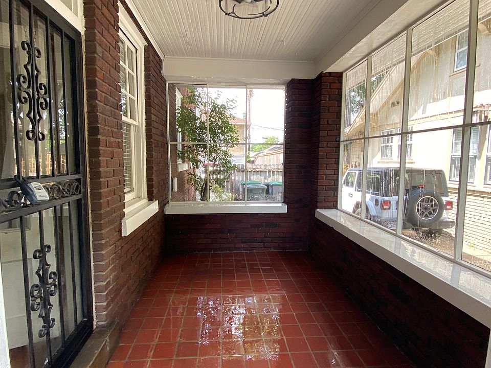 Covered, screened brick porch with ceiling fan.