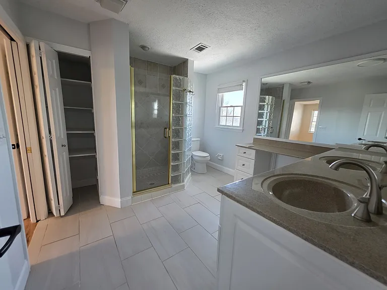 Master bath with custom cabinetry and 2 sinks