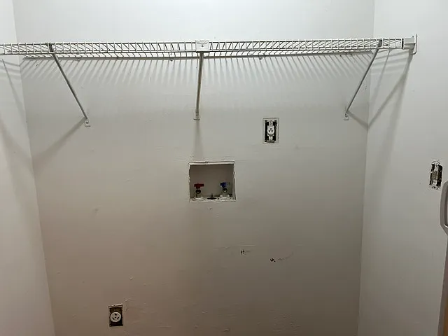 Washer Dryer hookups upstairs between bedrooms.