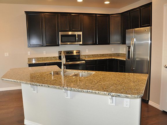 Kitchen with Big Granite Island and steel appliances