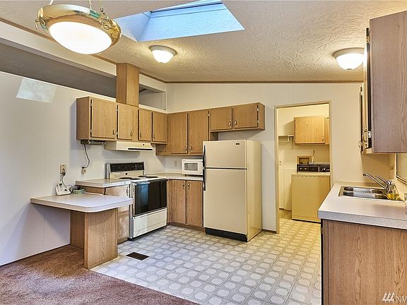 Open kitchen with skylight for extra natural lighting. 