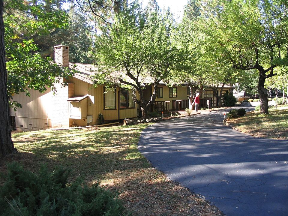 Private wooded acre of home on a court