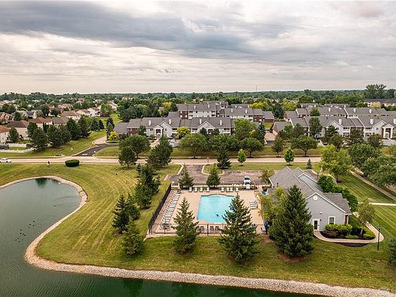 View at a pool, club house with fitness center.
