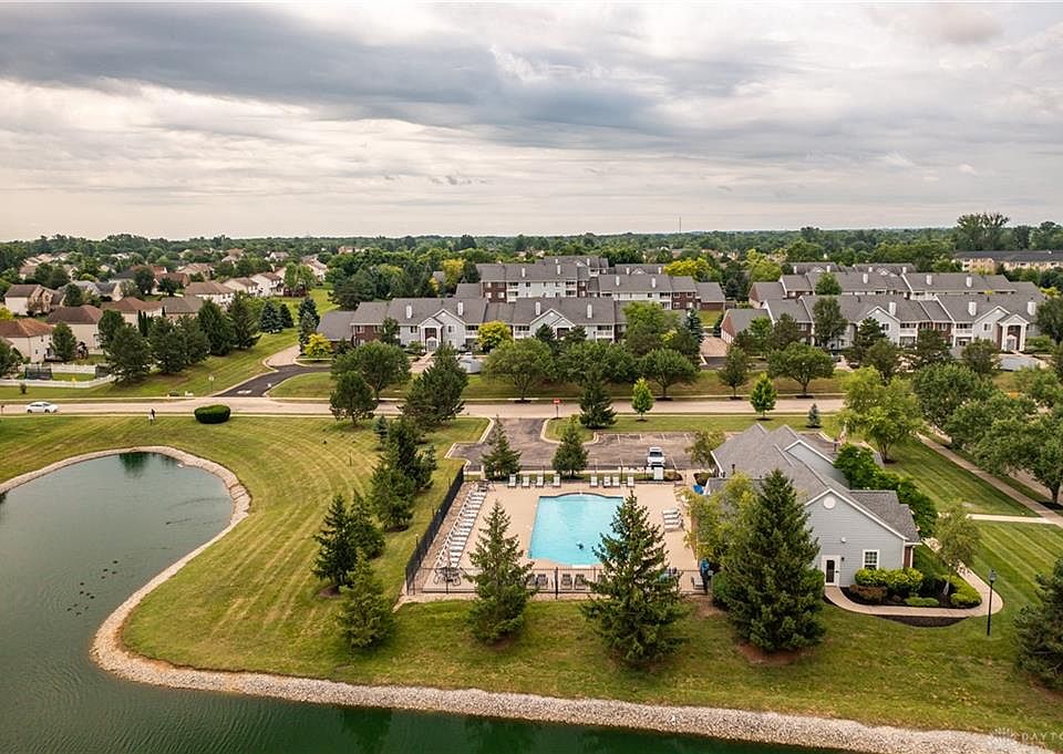 View at a pool, club house with fitness center.