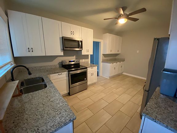 Large eat-in kitchen with granite countertops, extra storage and newer appliances.