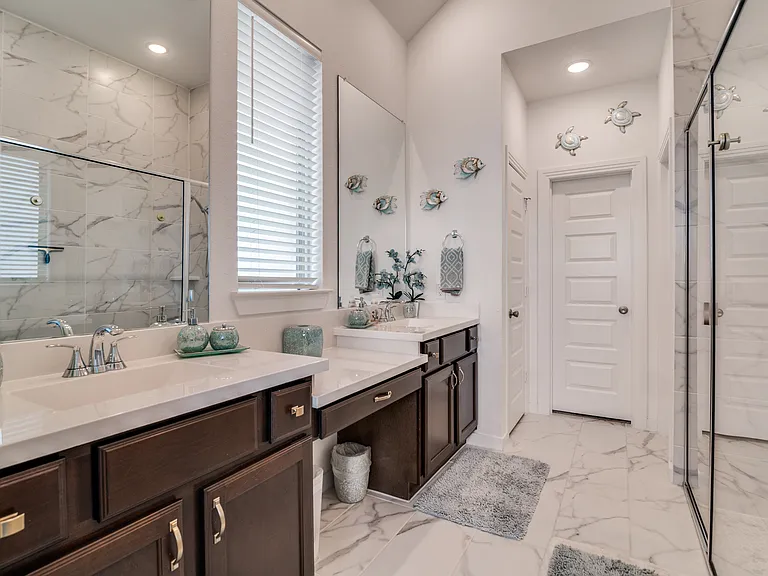 Master bathroom with a walk in closet