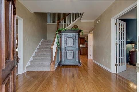 Foyer has gorgeous entry with den off to right.