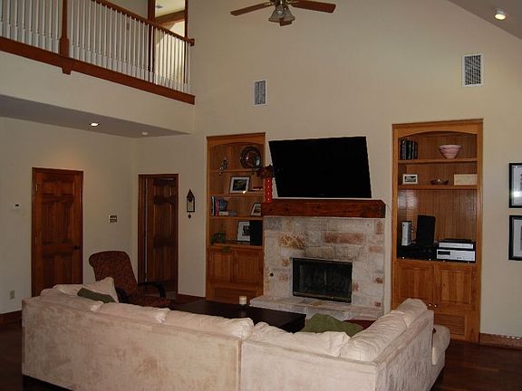 Living area features built-in hardwood cabinets.