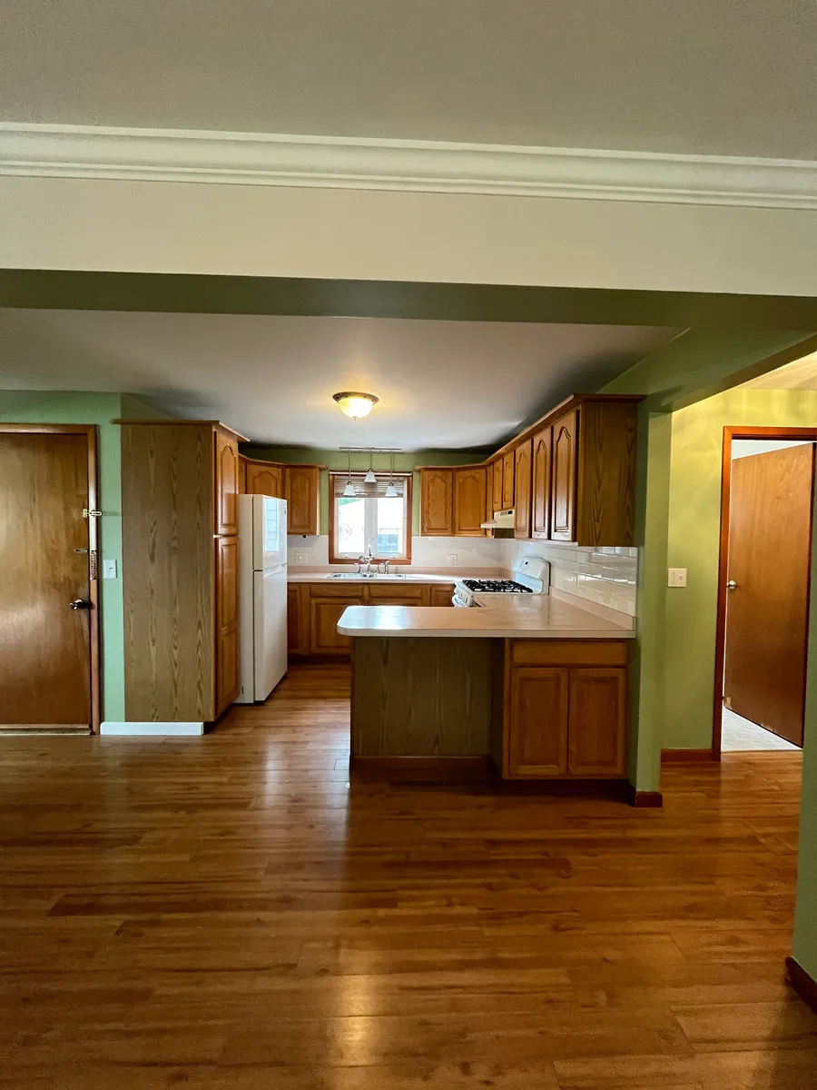 Standing in dining area looking toward kitchen. Entrance is door on the left. Bathroom is door on the right. - 620 E & West Rd