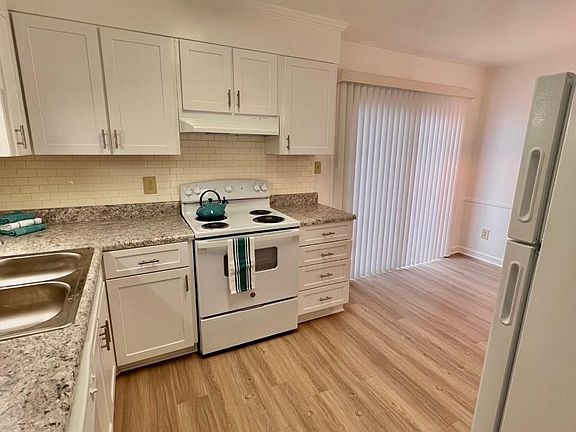 Updated cabinets with tile backsplash