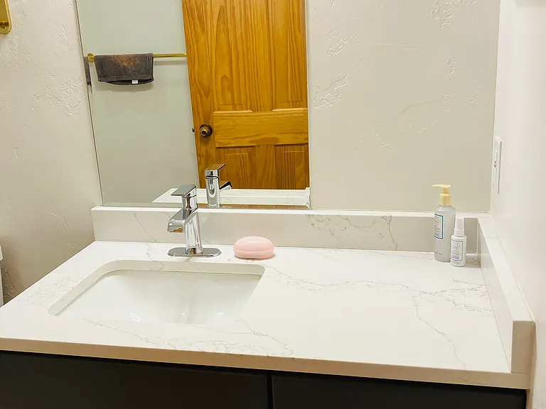 Bath with new countertop and sink.