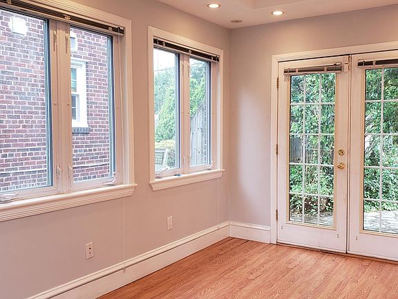 Light-filled office/sunroom with French doors that open onto flagstone patio.